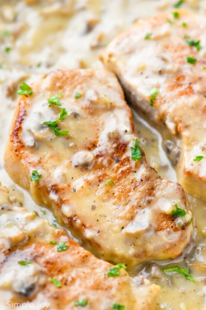 close up of a pork chop smothered in a creamy mushroom sauce