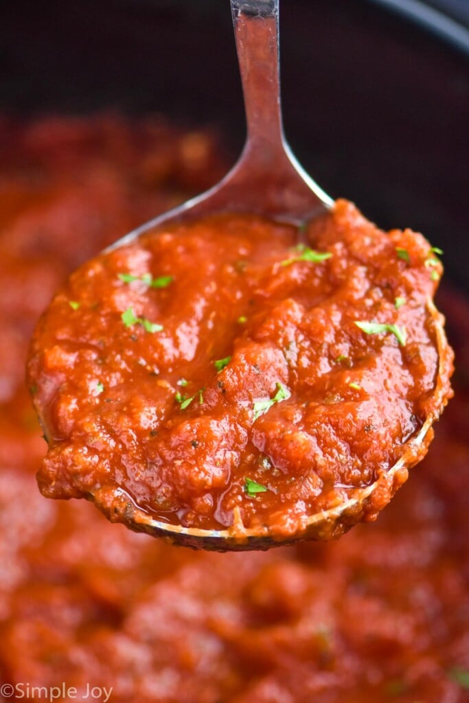 close up of a ladle of spaghetti sauce