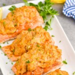pinterest graphic of four pieces of salmon stuffed with crab on a platter