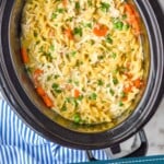 pinterest graphic of overhead of crockpot chicken and noodles in a slow cooker