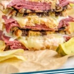 pinterest graphic of close up of a Reuben Sandwich stacked with all of the ingredients visible