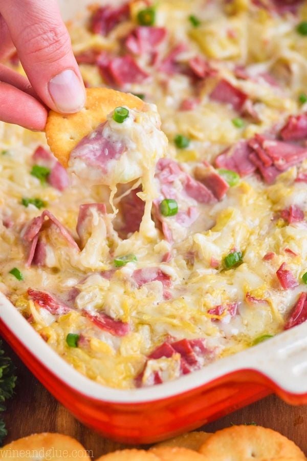 reuben dip being scooped up by a ritz cracker