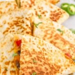 pinterest graphic of close up of cut up vegetarian quesadillas on a platter