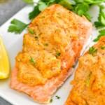 close up of crab stuffed salmon on a platter garnished with parsley