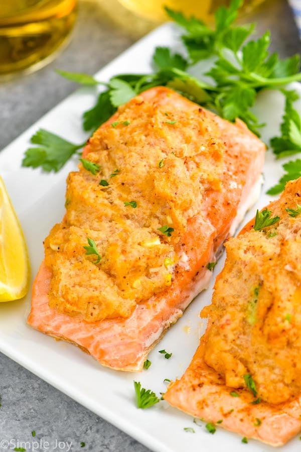 close up of crab stuffed salmon on a platter garnished with parsley
