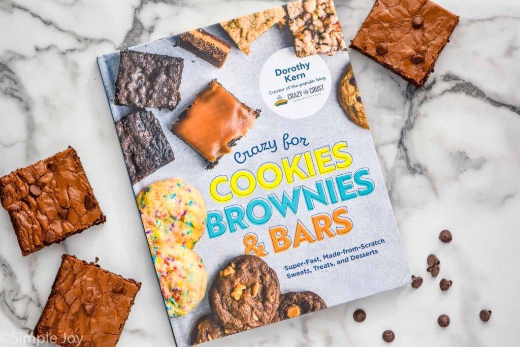 overhead picture of the book crazy for cookies brownies and bars with three brownies next to it