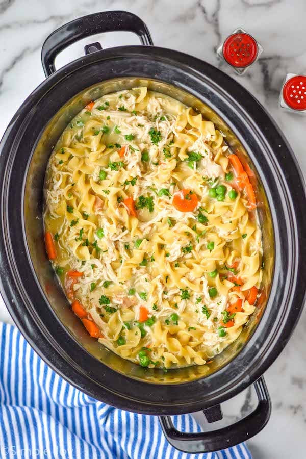 overhead of crockpot chicken and noodles in a slow cooker