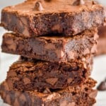 a stack of four chocolate brownies with the top one missing a bite - 8