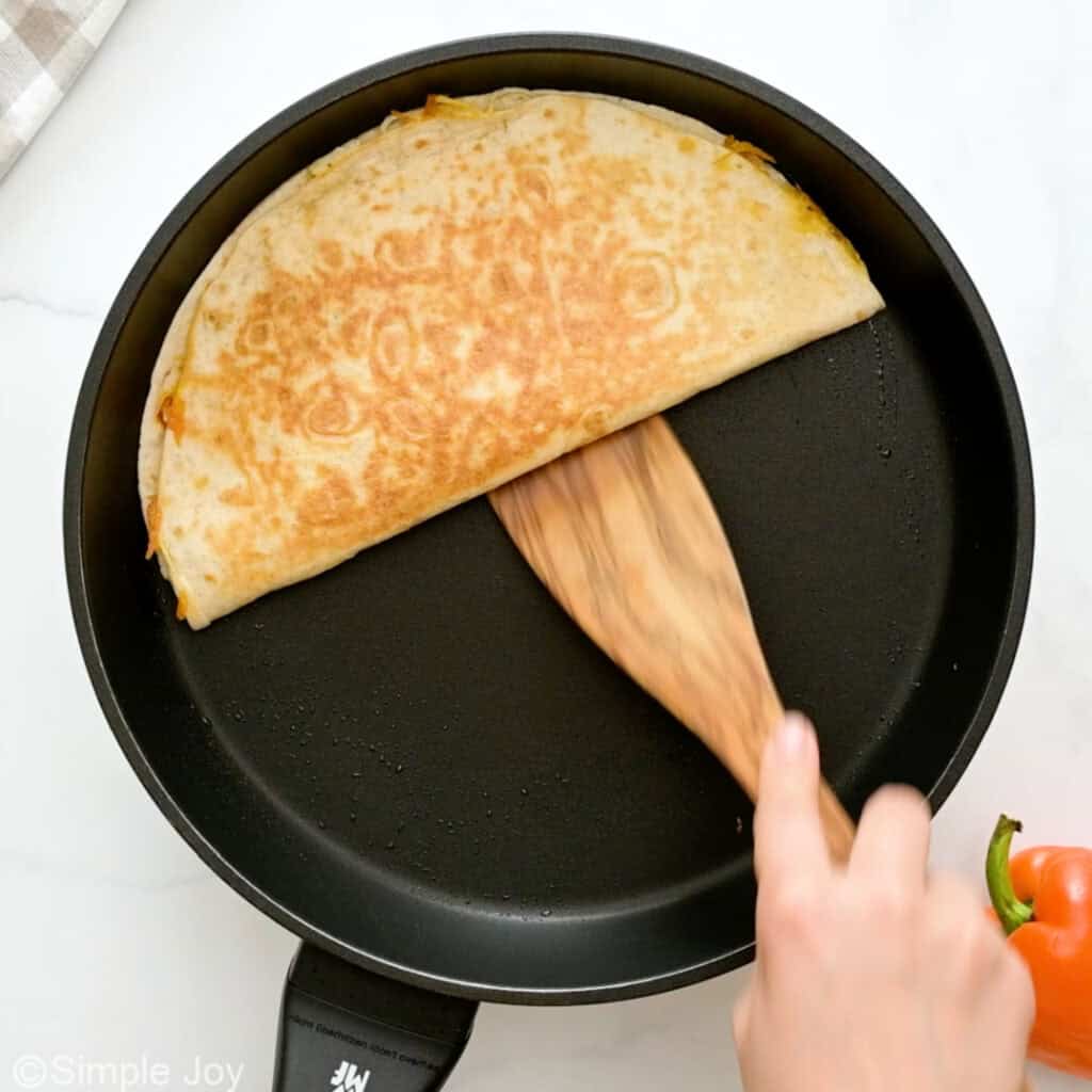 overhead of a half moon quesadilla in a skillet