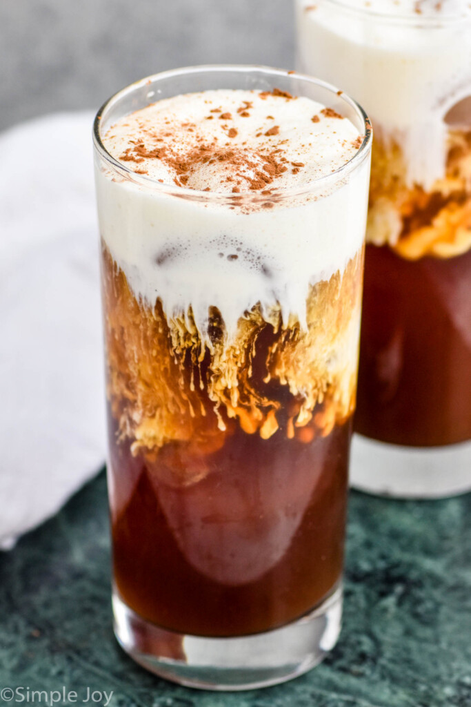 close up of an Irish cream cold brew topped with cream and garnished with coco powder