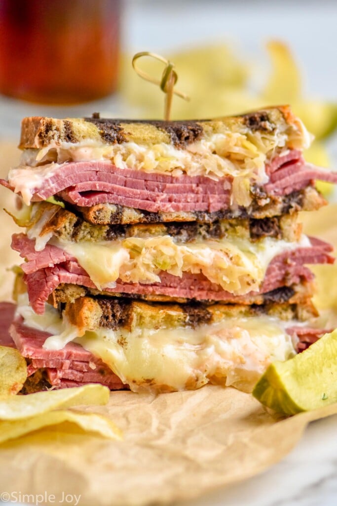 close up of a Reuben Sandwich stacked with all of the ingredients visible