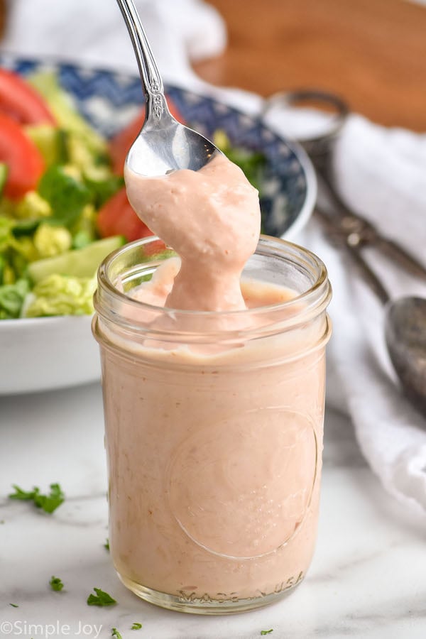 Russian dressing being spooned up from a mason jar