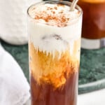 Starbucks Irish cream cold brew copy cat in a tall glass with foam, cocoa powder and a metal straw