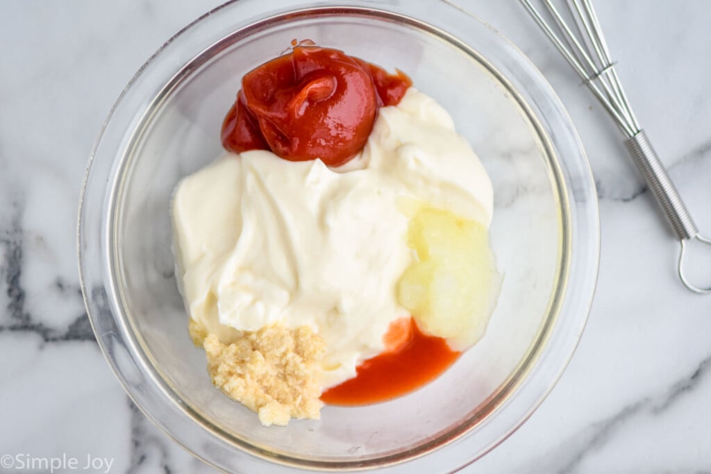 overhead of Russian dressing being broken up by ingredient