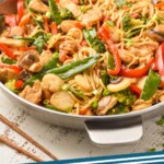 pinerest graphic of side view of a skillet full of chicken lo mein