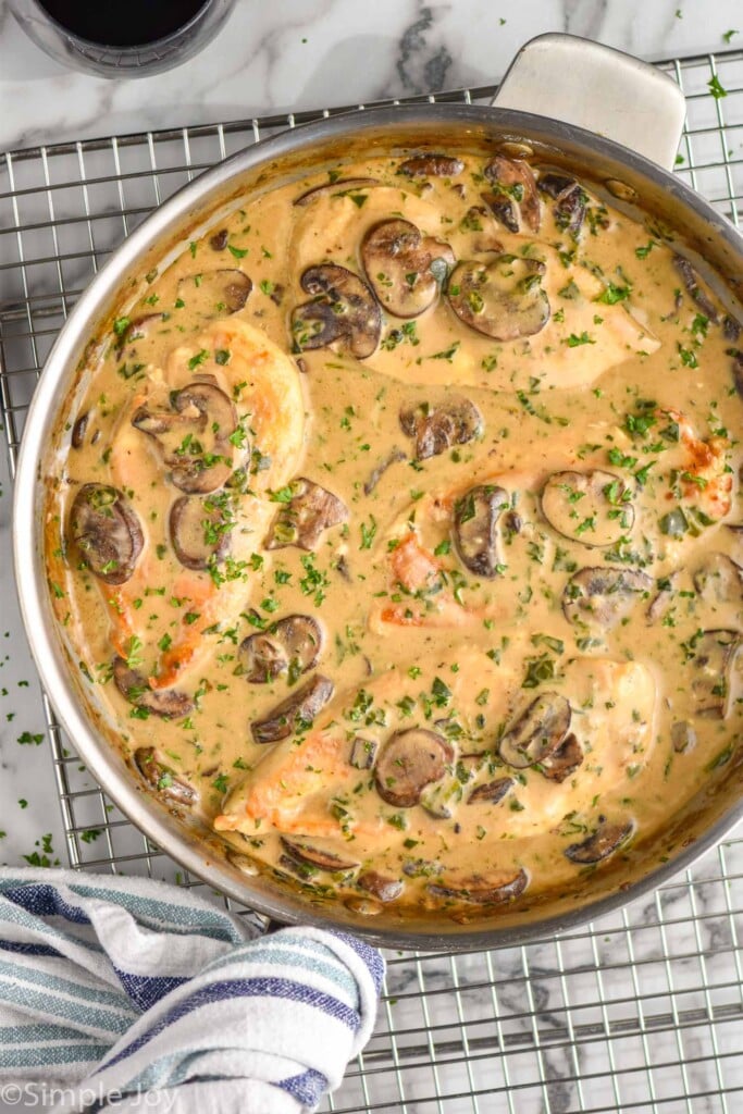 overhead of mushroom chicken in a skillet garnished with fresh parsley