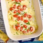 pinterest graphic of overhead picture of a baking dish full of pesto chicken