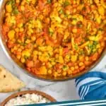 Pinterest graphic of overhead view of curry vegetables in a skillet