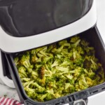 an air fryer with air fryer broccoli recipe in the basket - 9