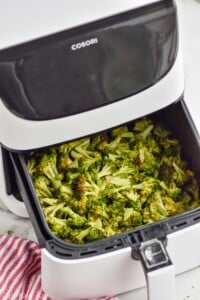an air fryer with air fryer broccoli recipe in the basket