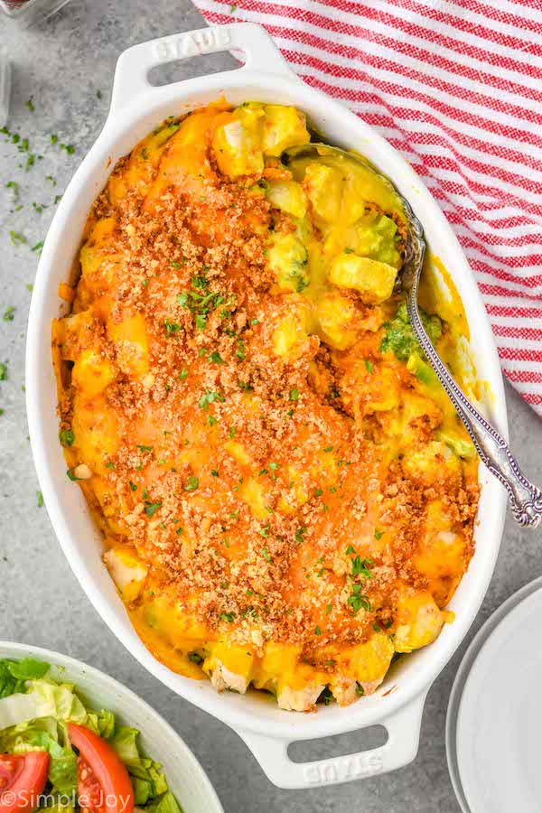 overhead of serving spoon in a casserole dish full of chicken divan