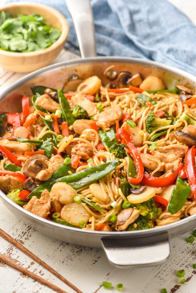 side view of a skillet full of chicken lo mein