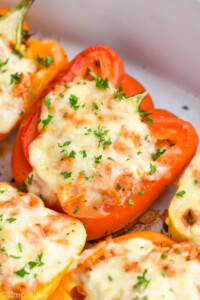 close up of a chicken stuffed bell pepper in a casserole dish