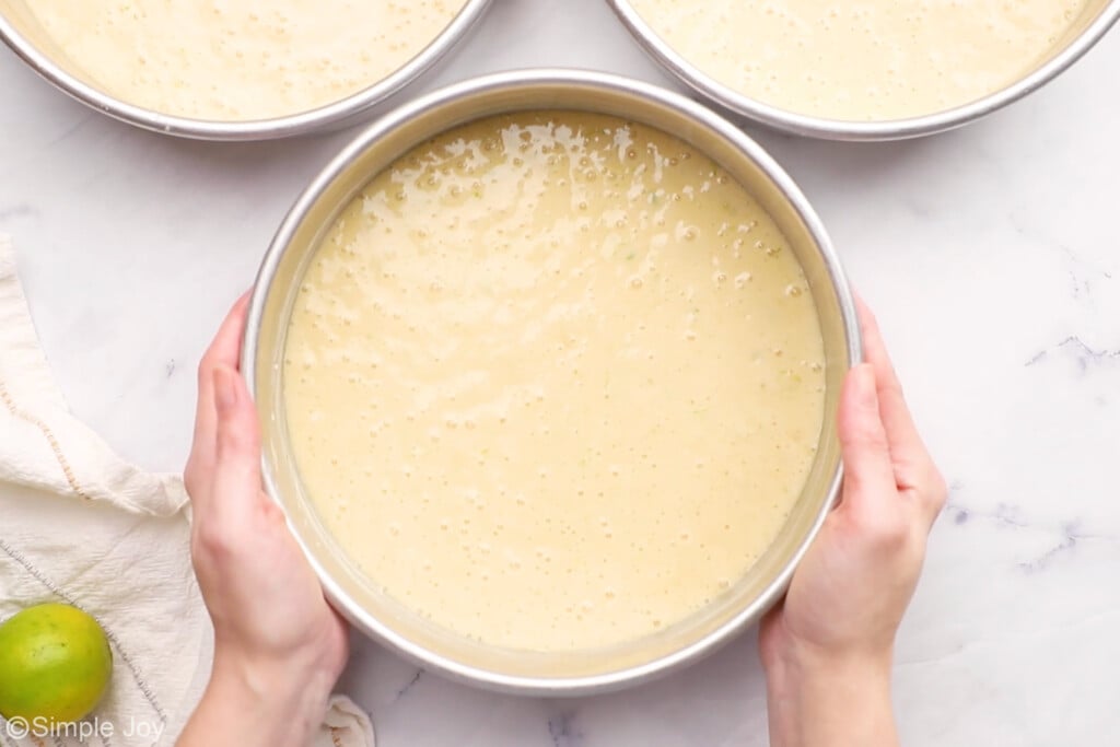cake batter divided between three pans