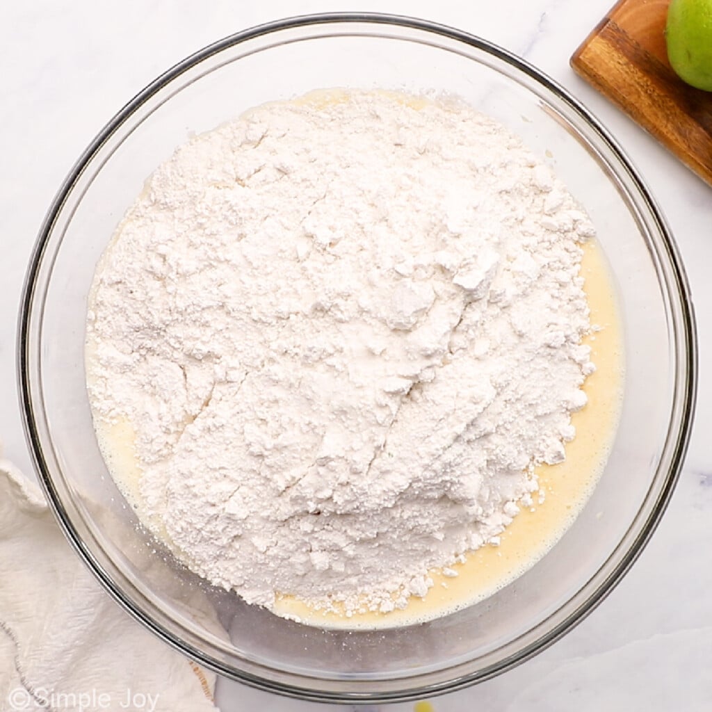 flour poured into wet ingredients in a bowl
