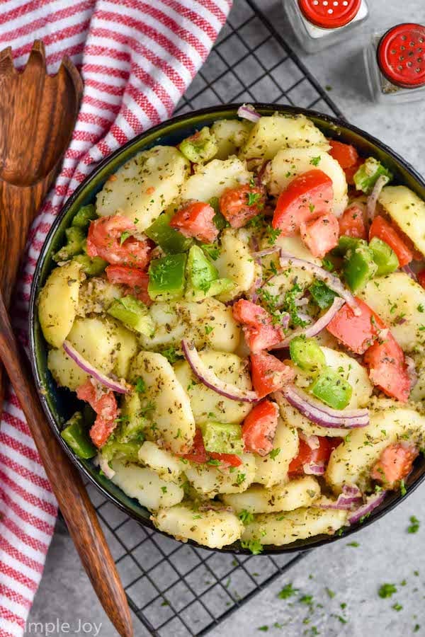 overhead of a bowl of italian potato salad in a serving bowl garnished with fresh parsley