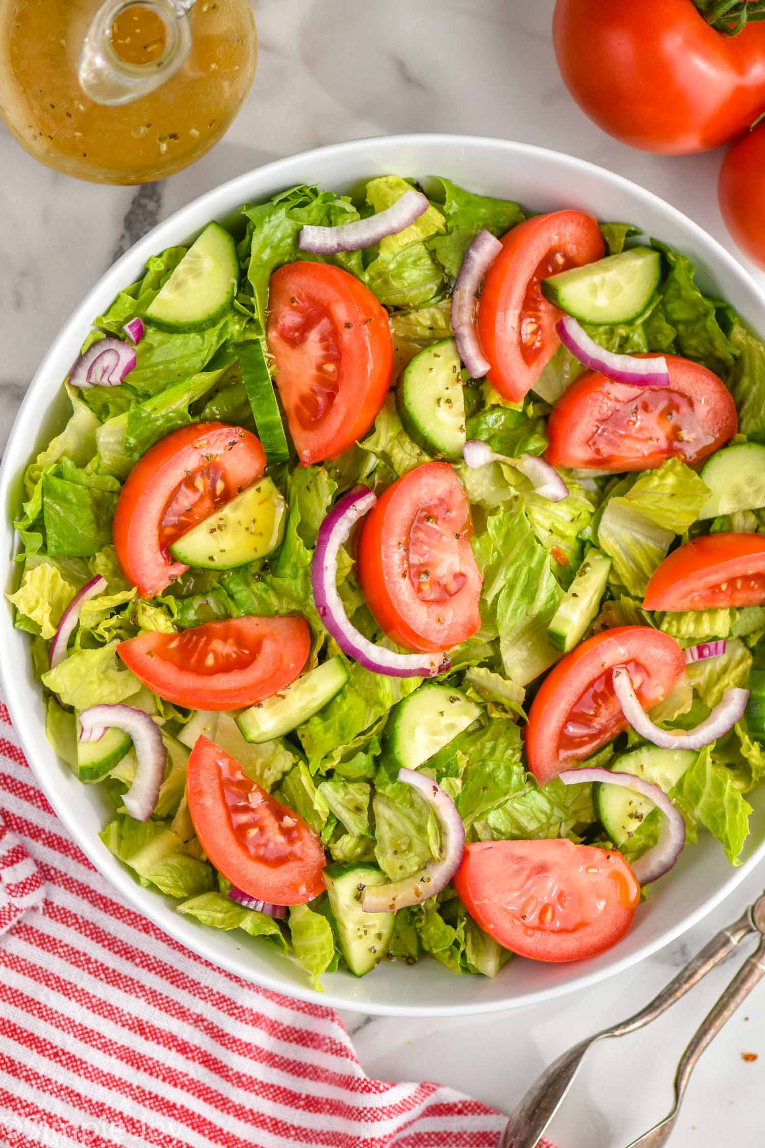 overhead of a salad dressed with italian salad dressing