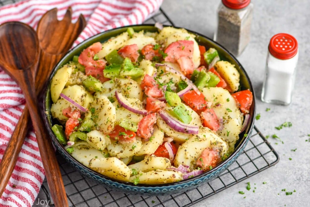 side view of a bowl of potato salad with italian seasonings