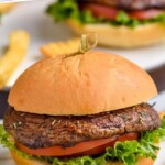 pinterest graphic of portobello burger on a bun with lettuce and tomato and fries next to it