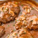 pinterest graphic of side view of a Salisbury steak recipe in a pan with gravy, garnished with parsley