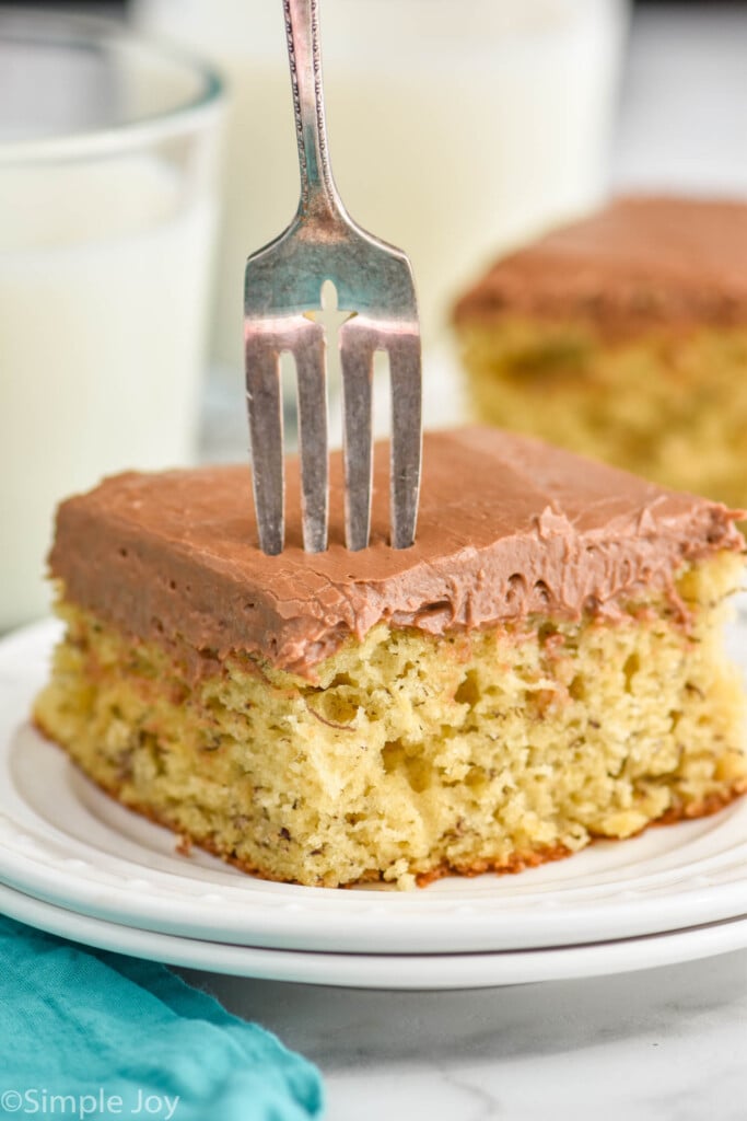 piece of banana cake recipe on a plate with a fork pushing into it