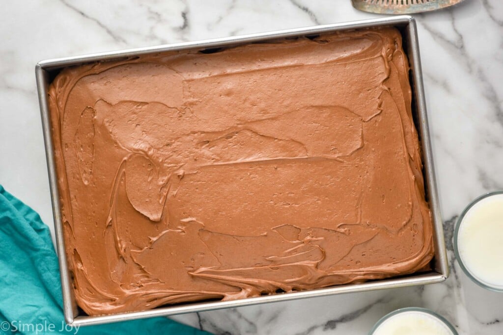 overhead picture of a 9 by 13 inch metal baking pan full of easy banana cake with chocolate frosting