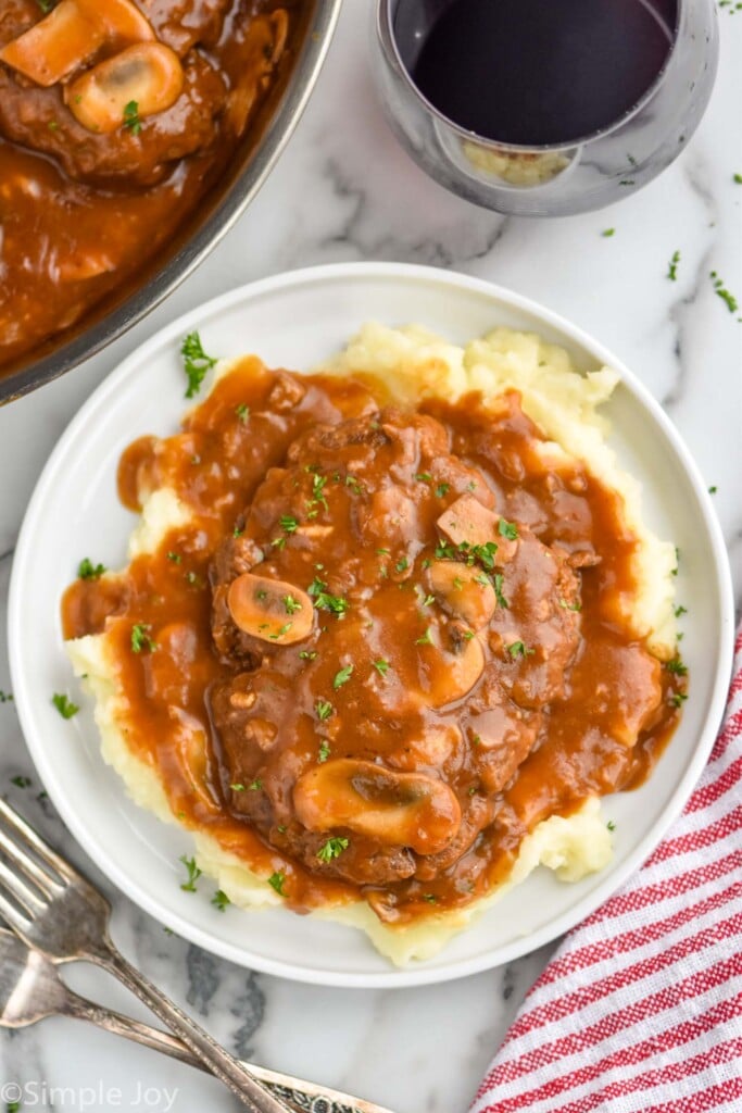 overhead of a plate of homemade Salisbury steak on a bed of mashed potatoes