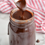 jar of hot fudge recipe with spoon dripping it in to the jar