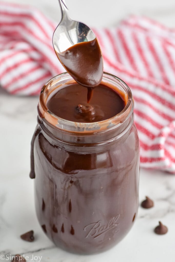 jar of hot fudge recipe with spoon dripping it in to the jar
