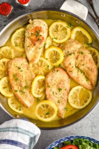 overhead of lemon pepper chicken in a skillet