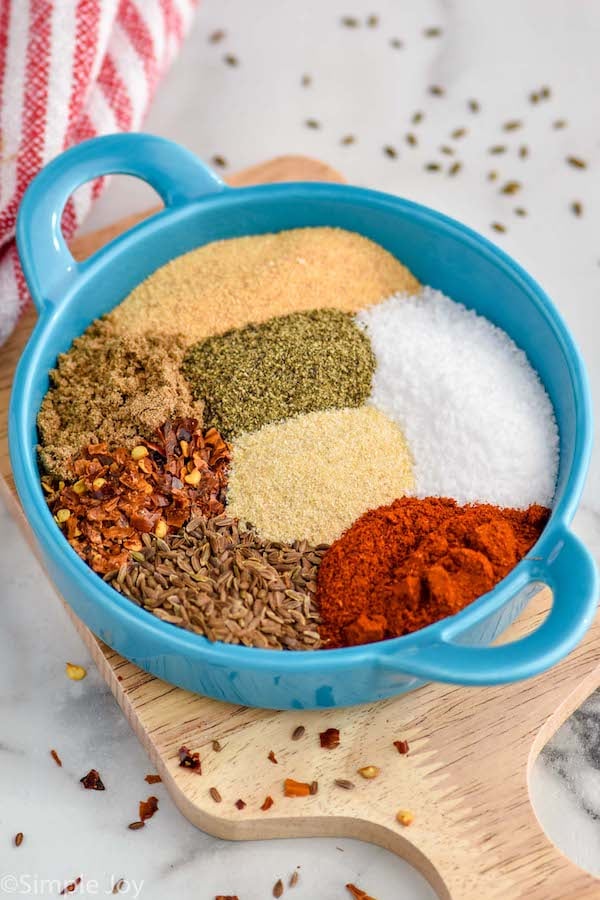 Overhead photo of Montreal Steak Seasoning ingredients combined in a blue bowl.