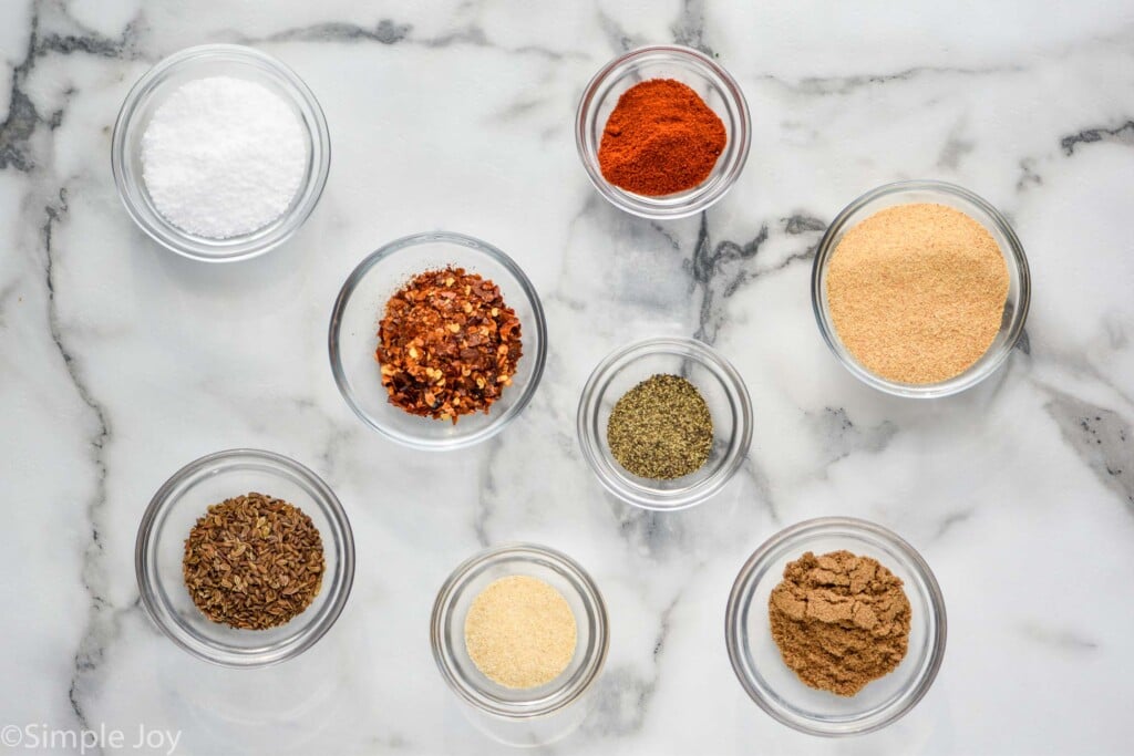 Overhead photo of Montreal Steak Seasoning ingredients in individual clear bowls.