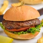 portobello burger on a bun with lettuce and tomato and fries next to it - 11