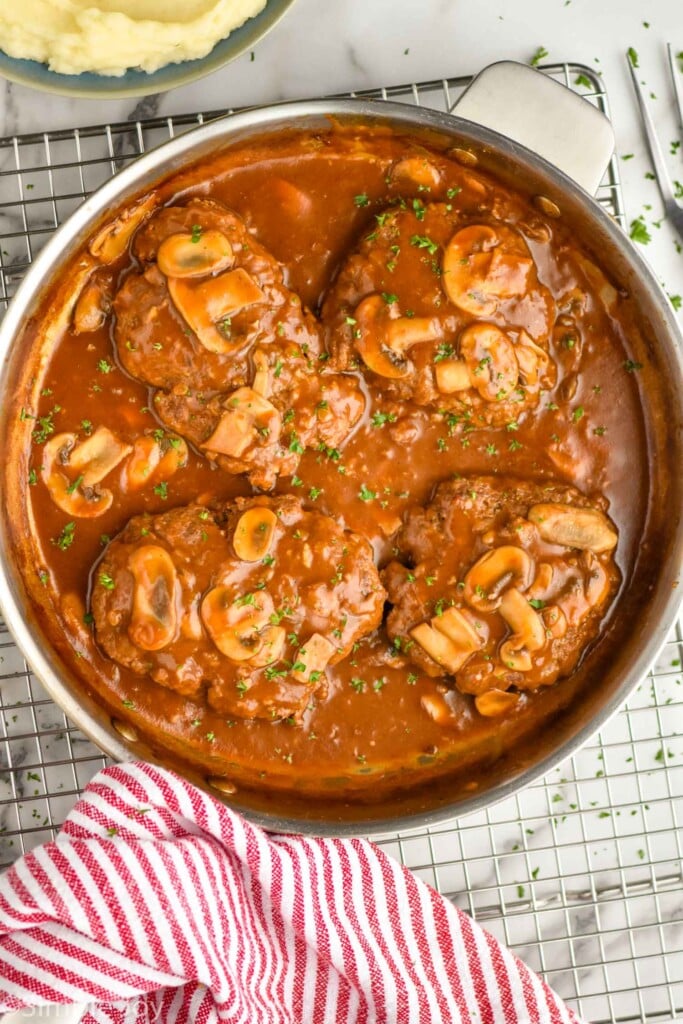 overhead of a skillet full of Salisbury steak