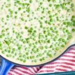 Pinterest graphic of creamed peas recipe. Overhead photo of creamed peas in a pan. Text says, "The very best creamed peas simplejoy.com"