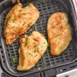 Overhead photo of air fryer chicken breasts in air fryer basket