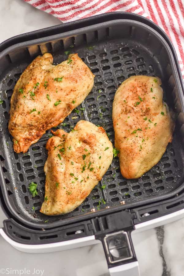 Overhead photo of air fryer chicken breasts in air fryer basket