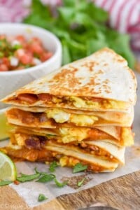 Overhead photo of breakfast quesadilla. Bowl of pico de gallo on the side for garnish.