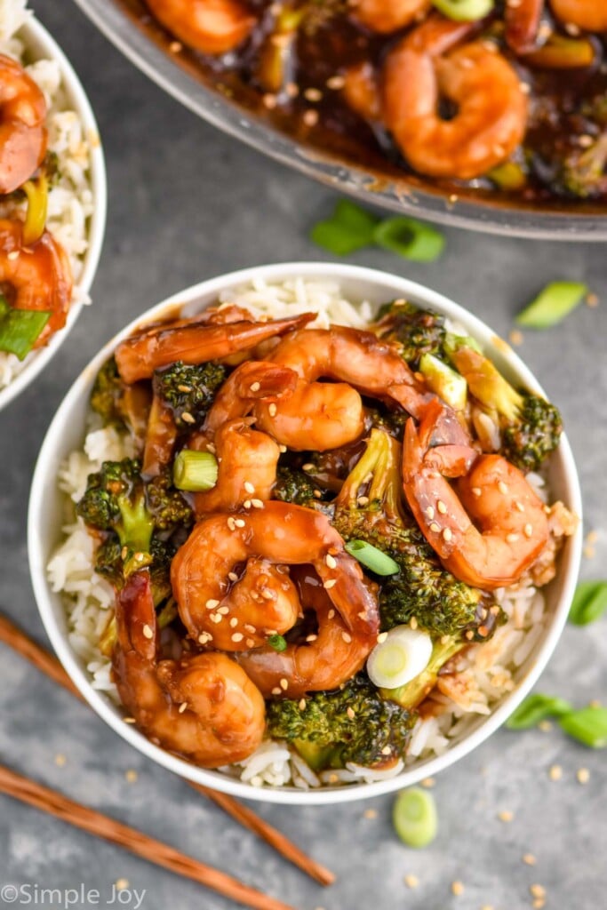 Overhead photo of shrimp and broccoli stir fry served in a white bowl over white rice.