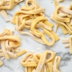 overhead of piles of raw egg noodles - 10